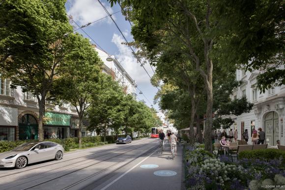 a street with a Flexity streetcar a biking lane and many trees and flower beds
